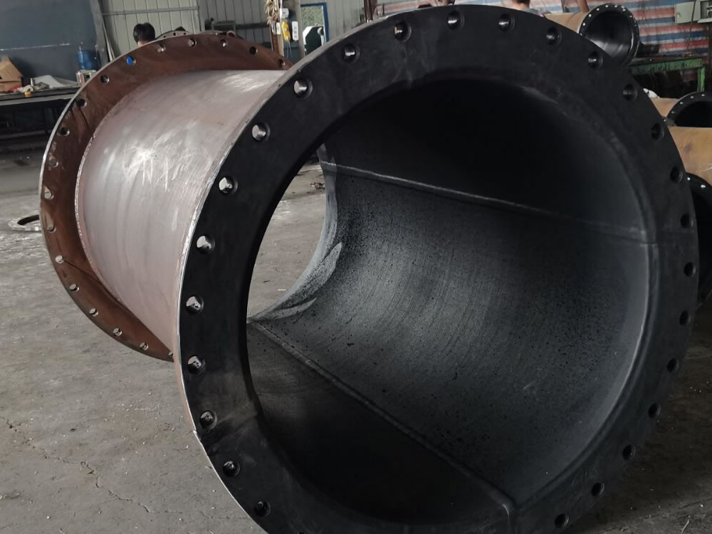 Close view inside a rubber-lined steel pipe and flange