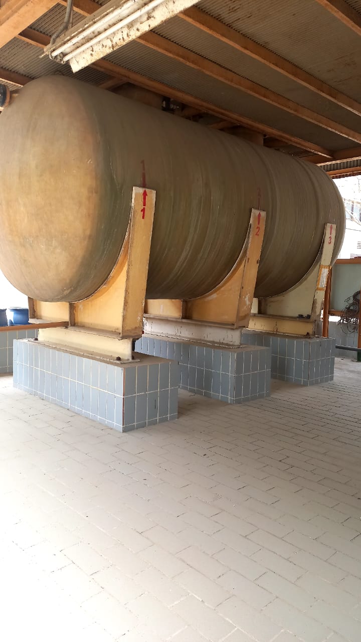 Large industrial storage vessel installed on structural supports