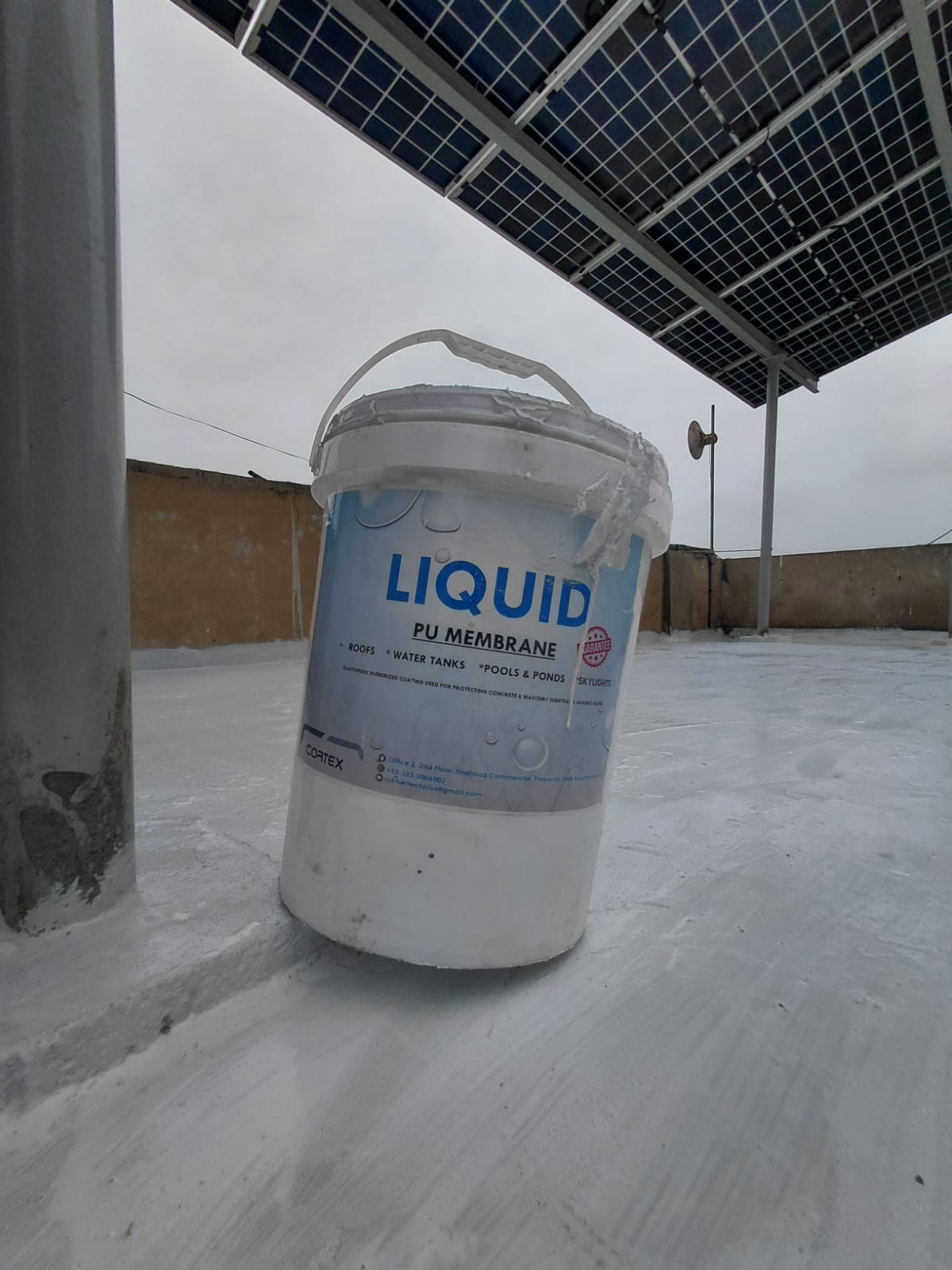 Liquid PU Membrane bucket displayed on a completed waterproofed roof