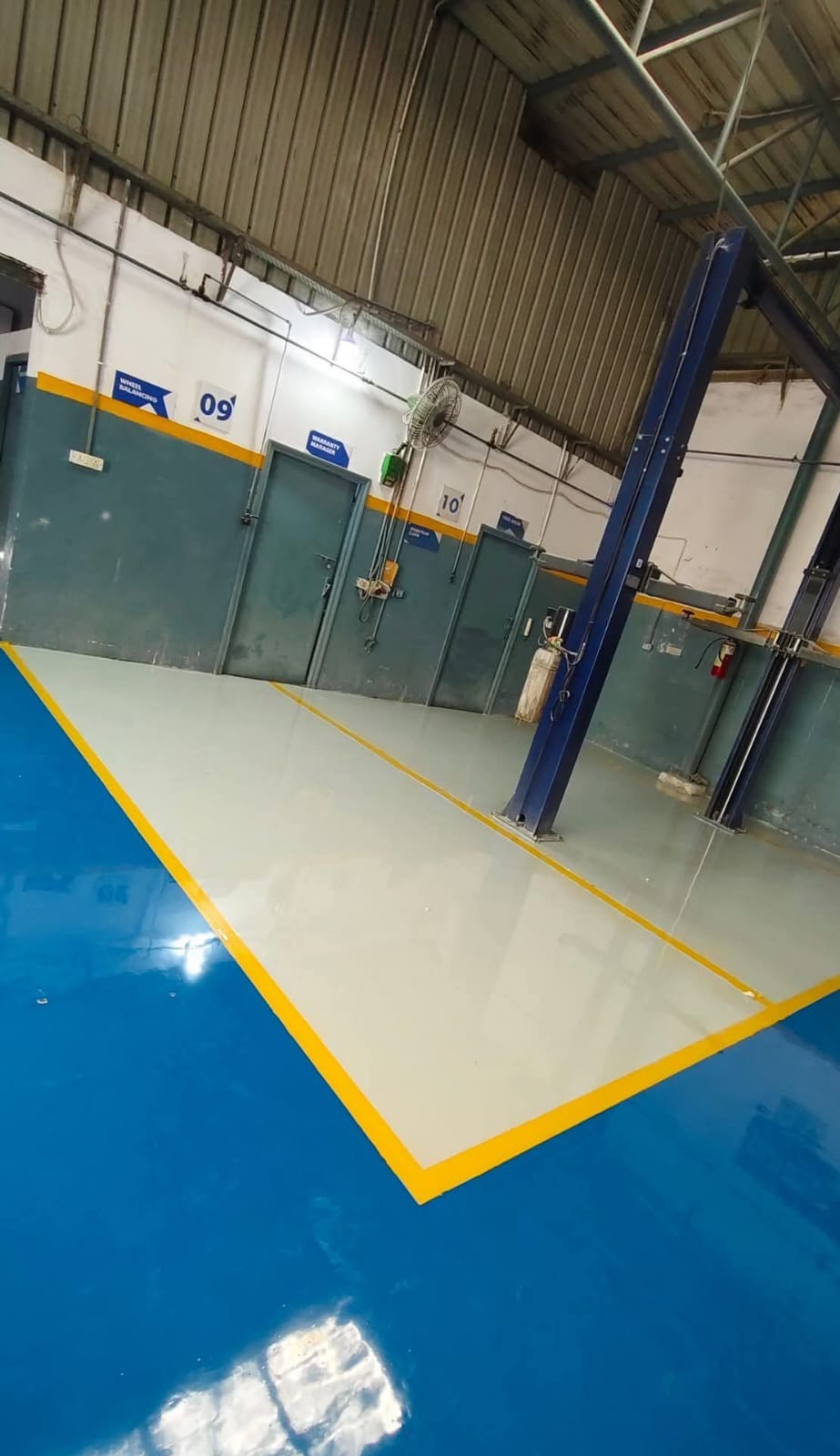 Epoxy floor around vehicle workshop lift bays