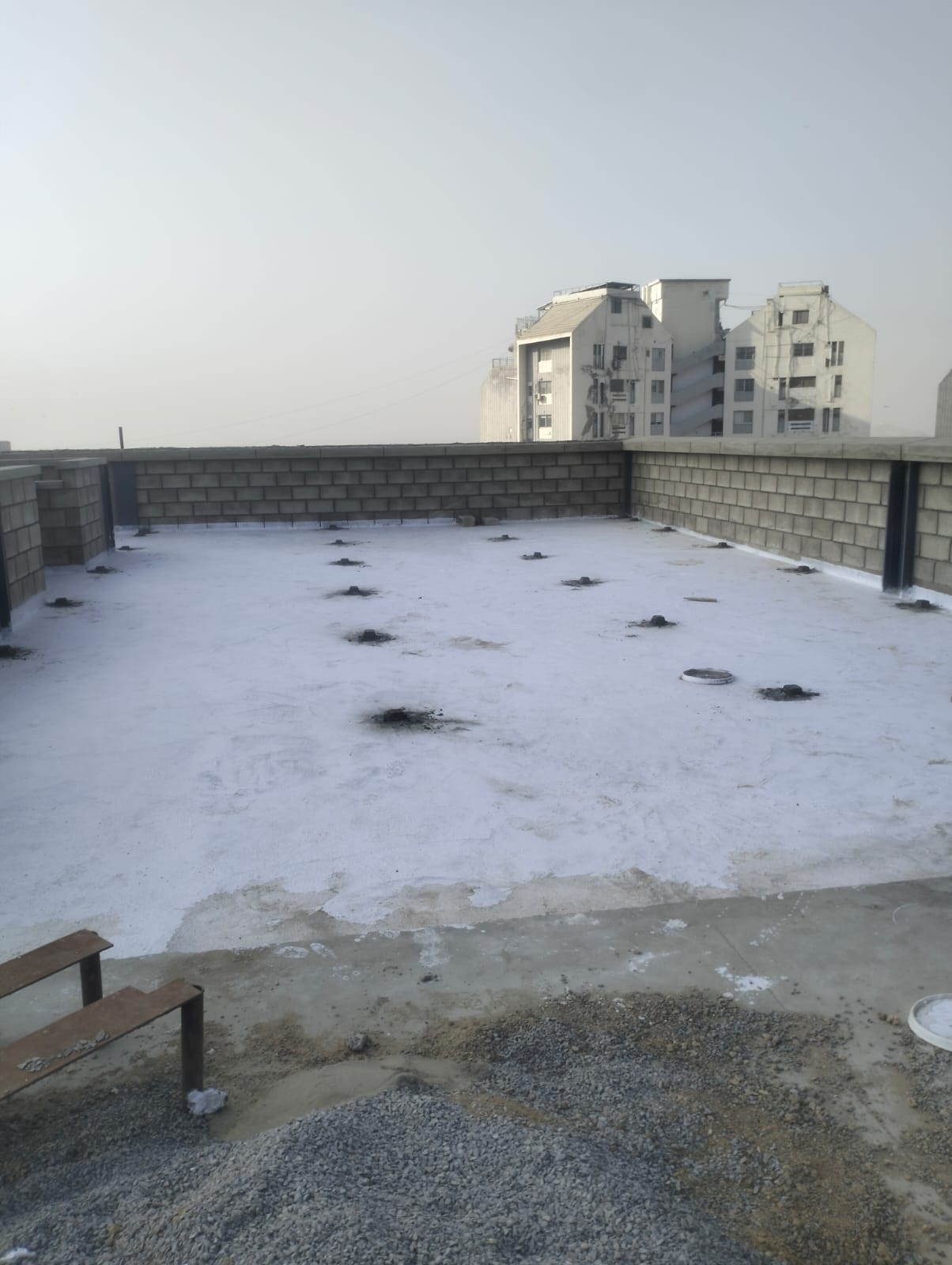 Completed white waterproofing membrane on a concrete rooftop