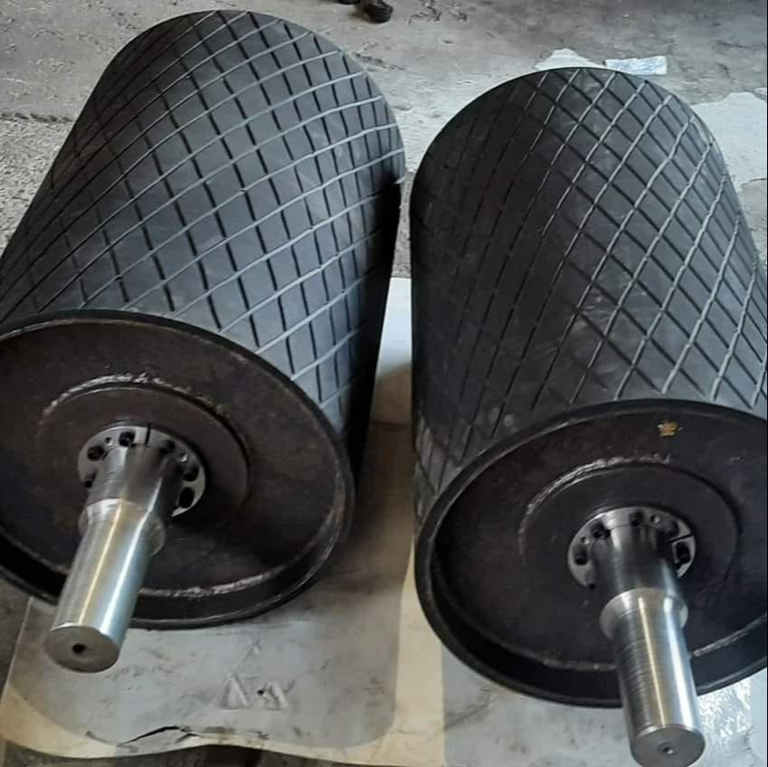 Pair of industrial rubber rollers with diamond-patterned surfaces