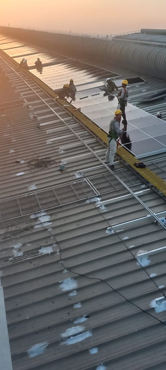 Industrial crew carrying out roof protection work on metal roofing