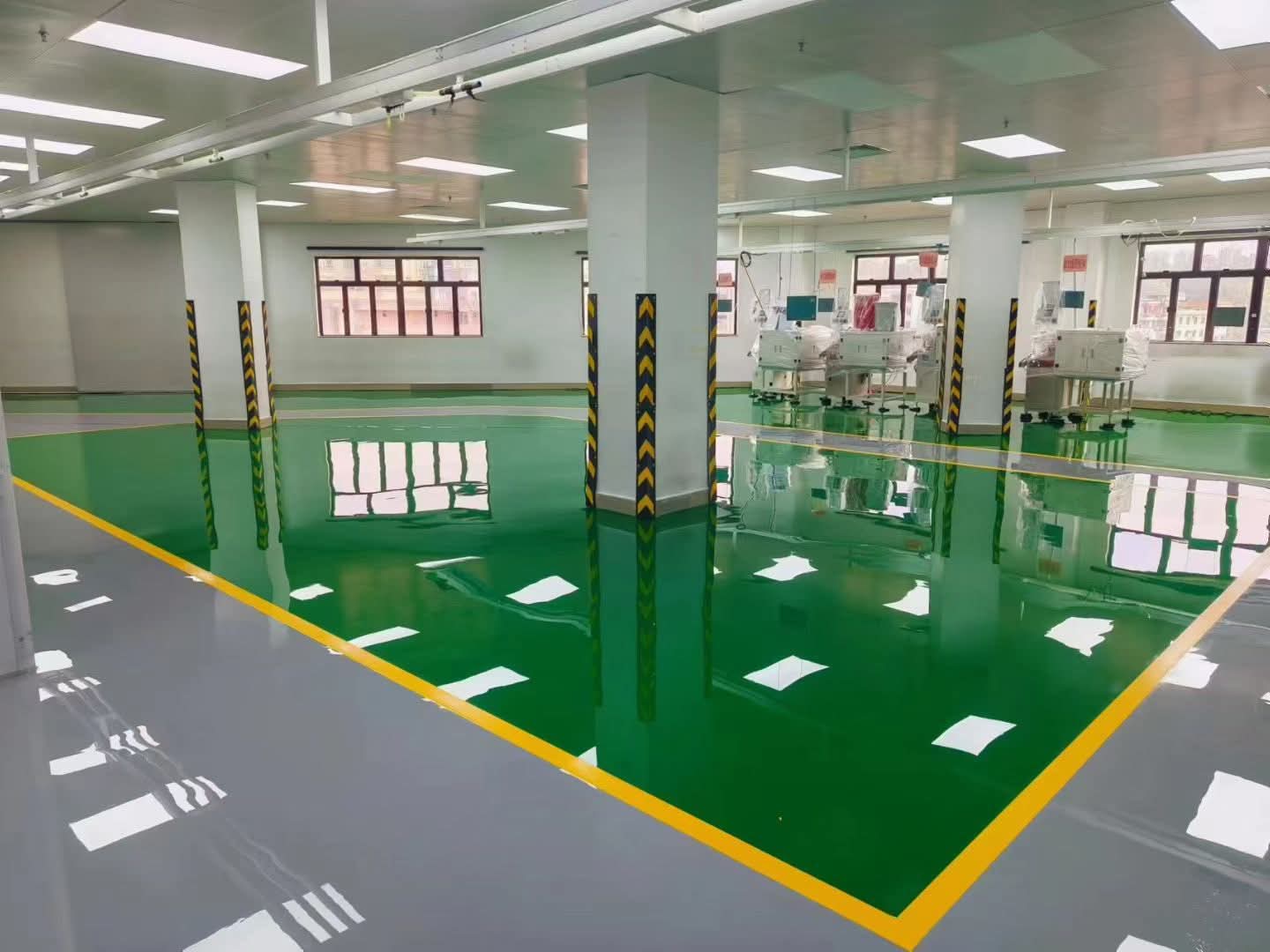 Glossy industrial epoxy floor with yellow safety markings