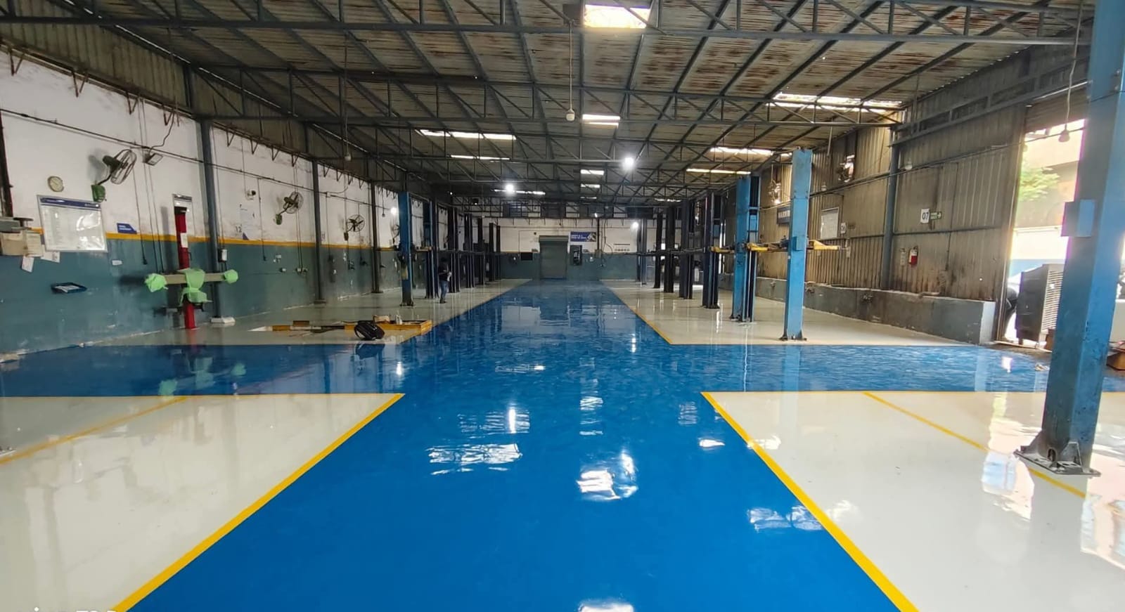 Blue and grey epoxy flooring in an industrial workshop