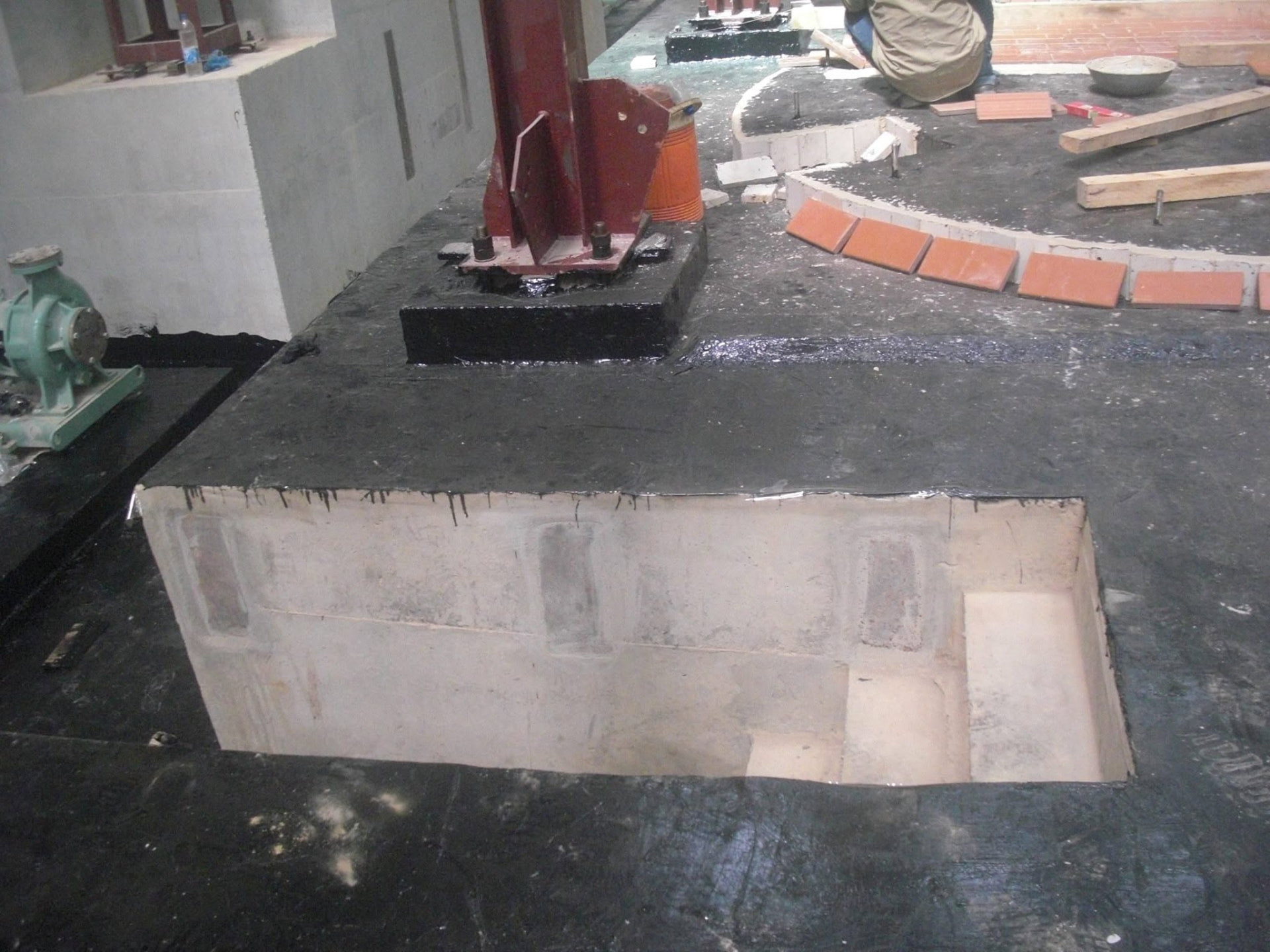 Chemical-resistant coating and tile detailing around process foundations